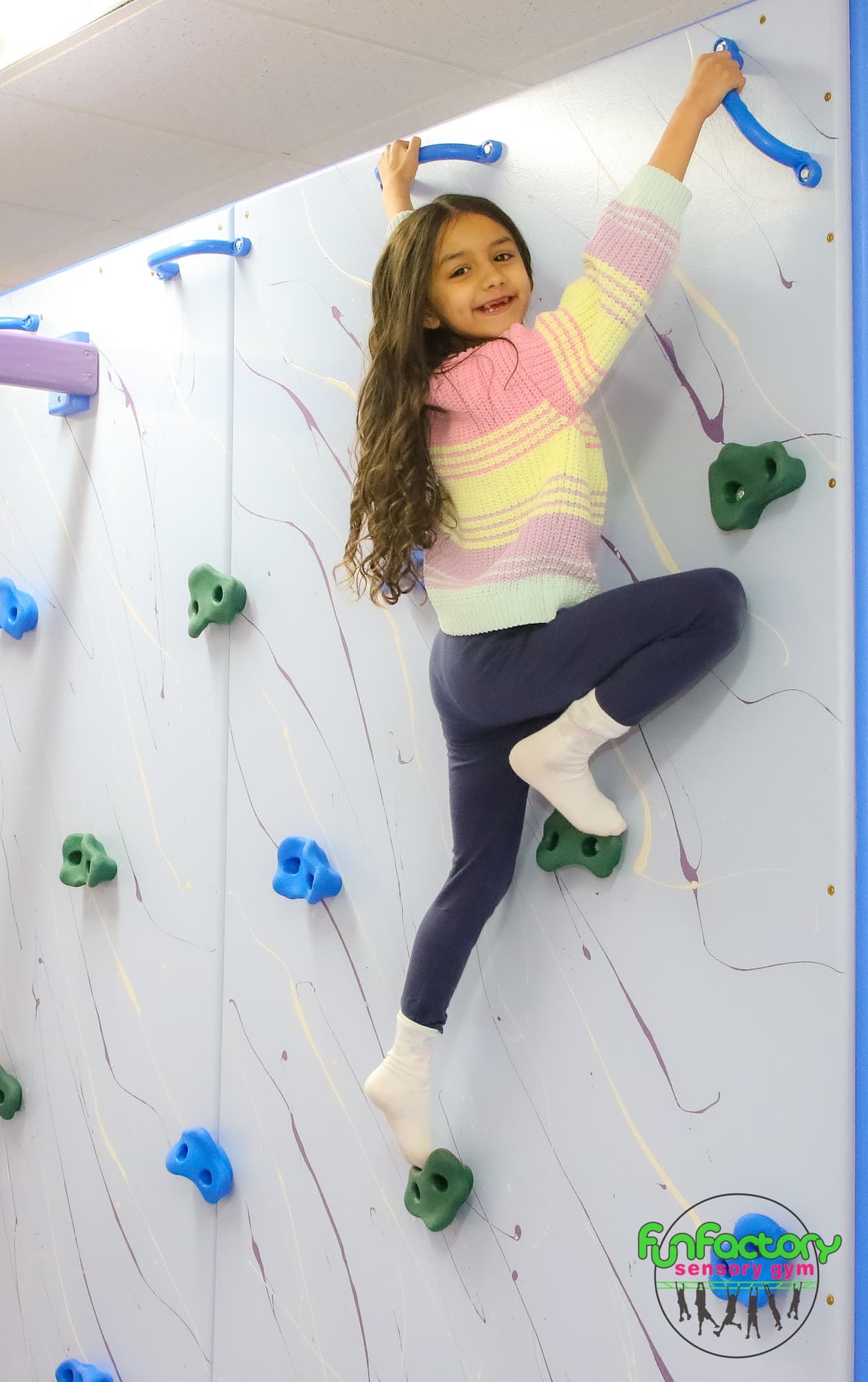 Child climbing in a safe sensory gym