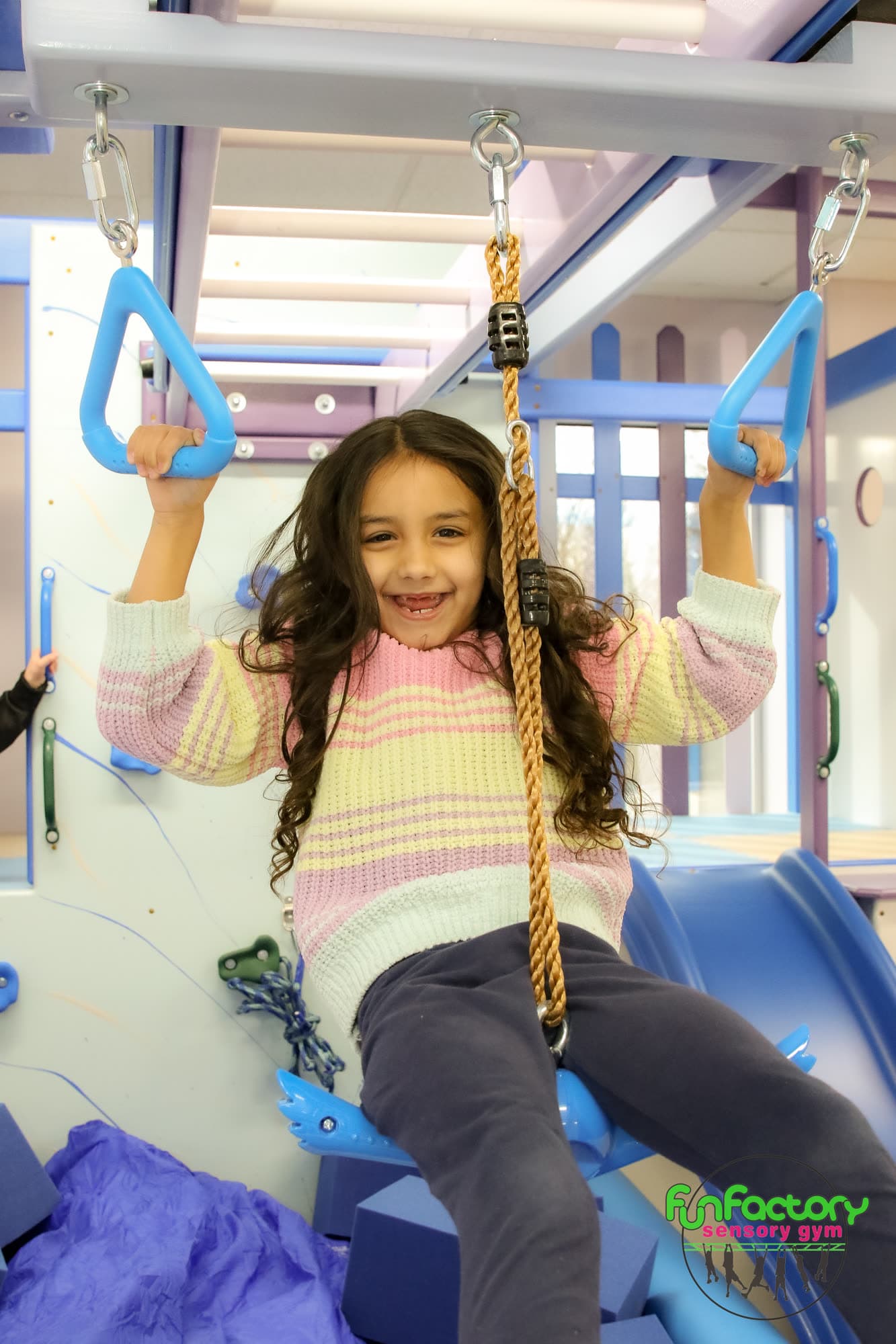 Child smiling on a sensory swing